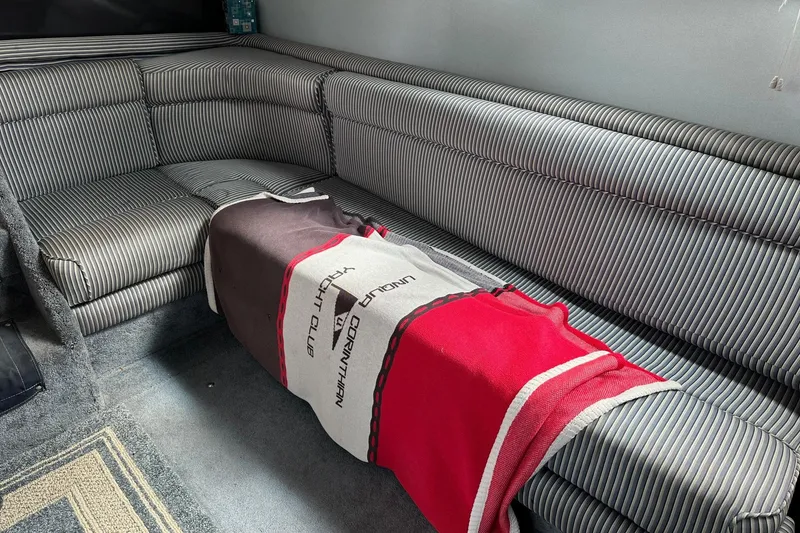 Slide: The Image of Striped seating area in a 1989 Sea Ray 380 Aft Cabin with a colorful blanket. - 13