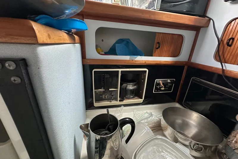 Slide: The Image of 1989 Sea Ray 380 Aft Cabin kitchen with coffee maker and utensils. - 17