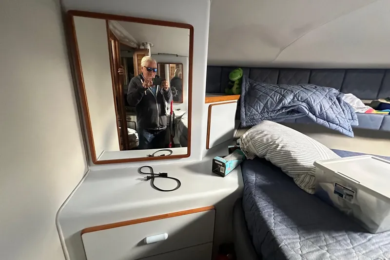 Slide: The Image of 1989 Sea Ray 380 Aft Cabin interior with mirror, bed, and personal items. - 21