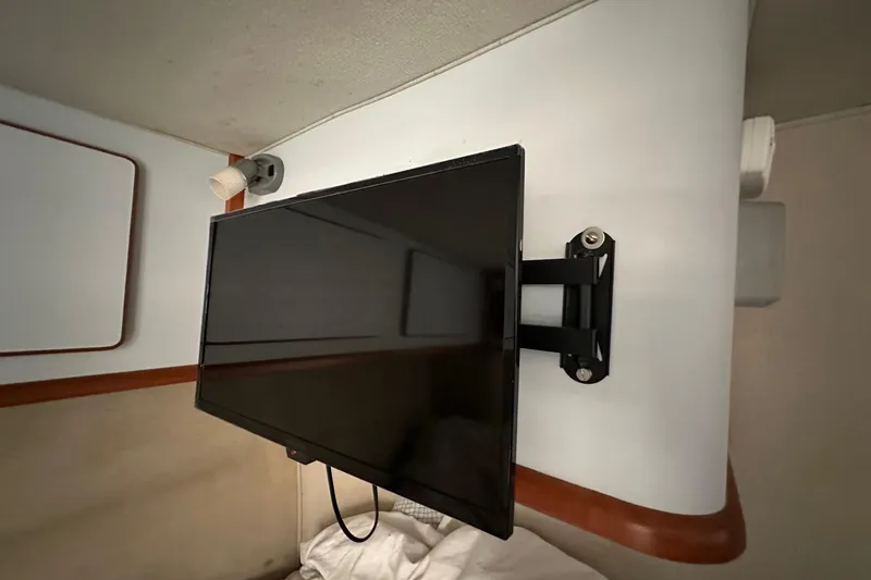 Slide: The Image of Wall-mounted TV in 1989 Sea Ray 380 Aft Cabin interior, featuring modern entertainment setup. - 22