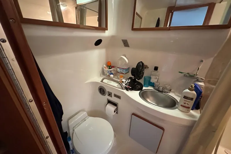 Slide: The Image of Compact bathroom in 1989 Sea Ray 380 Aft Cabin yacht, featuring sink and toilet. - 25