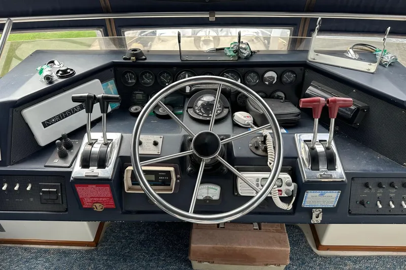 Slide: The Image of Control panel of a 1989 Sea Ray 380 Aft Cabin boat with steering wheel and gauges. - 6