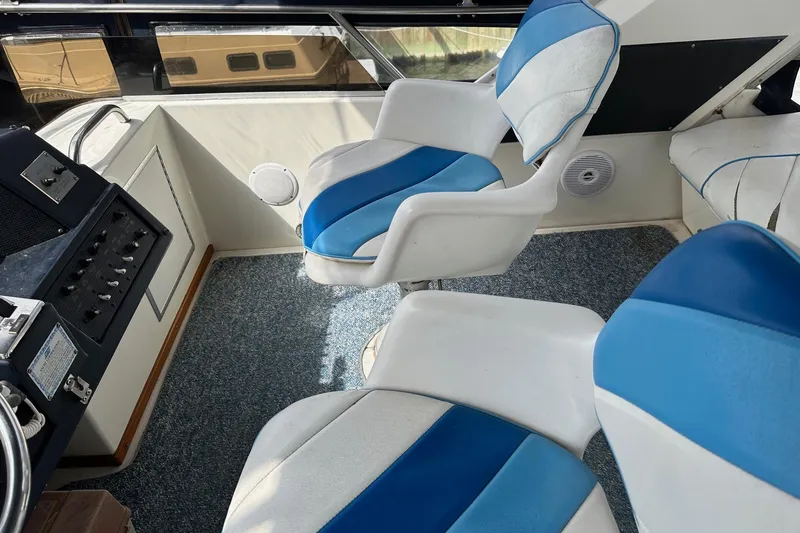 Slide: The Image of 1989 Sea Ray 380 Aft Cabin interior with blue and white seating and control panel. - 8
