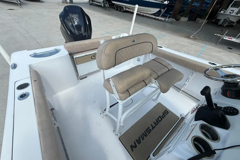Slide: The Image of 2019 Sportsman 232 OE boat interior with beige seating and steering console. - 11