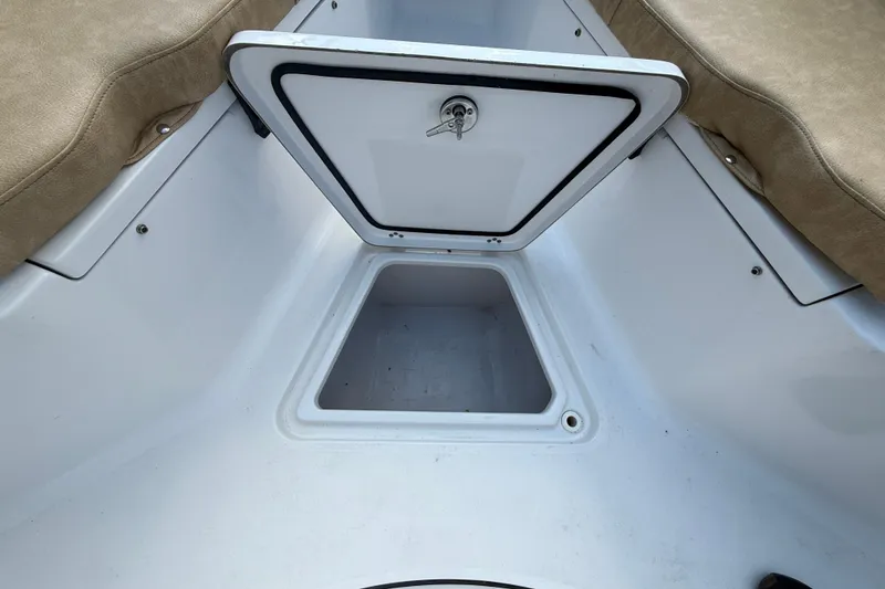 Slide: The Image of Open storage compartment on a 2019 Sportsman 232 OE boat with beige seating. - 19
