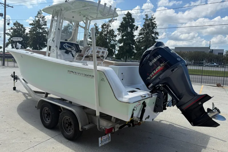Slide: The Image of 2019 Sportsman 232 OE boat on trailer with Yamaha outboard motor, parked outdoors. - 5