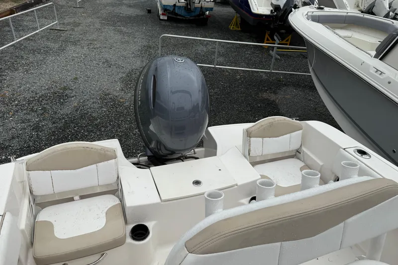 Slide: The Image of 2019 Robalo R180 Center Console boat with Yamaha outboard motor, docked on gravel. - 10