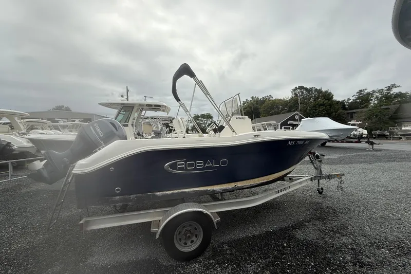 Slide: The Image of 2019 Robalo R180 Center Console boat on trailer, overcast day. - 4