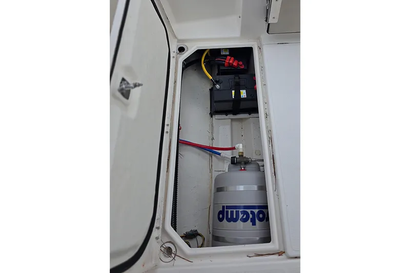 Slide: The Image of 2020 Cutwater C-24 boat compartment with battery and water heater. - 10