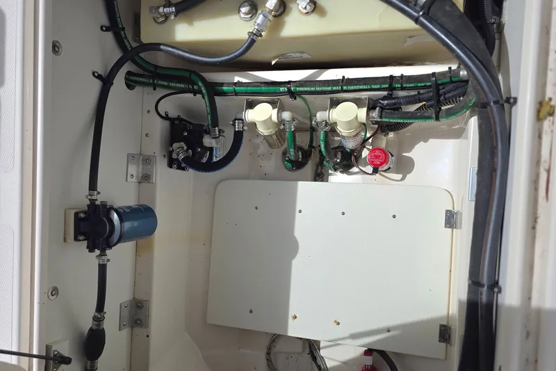 Slide: The Image of 2020 Cutwater C-24 engine compartment with hoses, filters, and wiring. - 11