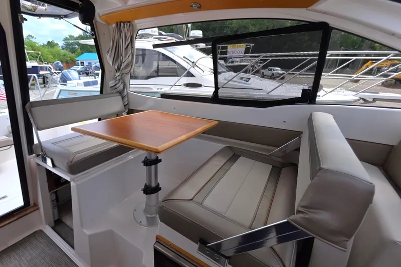 Slide: The Image of Interior of a 2020 Cutwater C-24 boat with seating and a wooden table. - 18