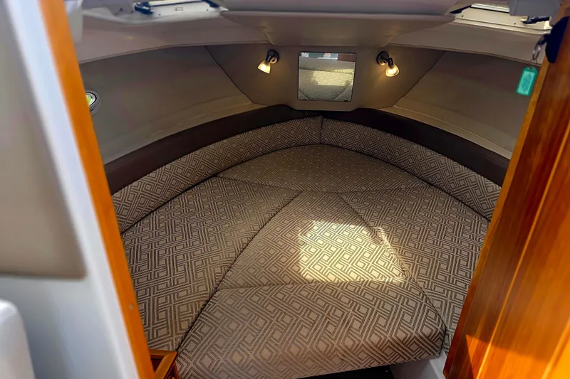Slide: The Image of 2020 Cutwater C-24 cabin interior with patterned cushions and ambient lighting. - 26