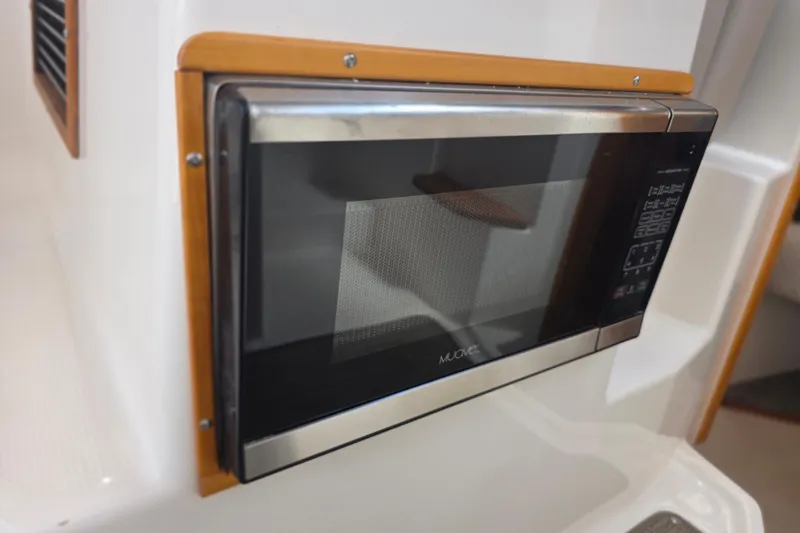 Slide: The Image of Built-in microwave in 2020 Cutwater C-24 boat interior. - 27