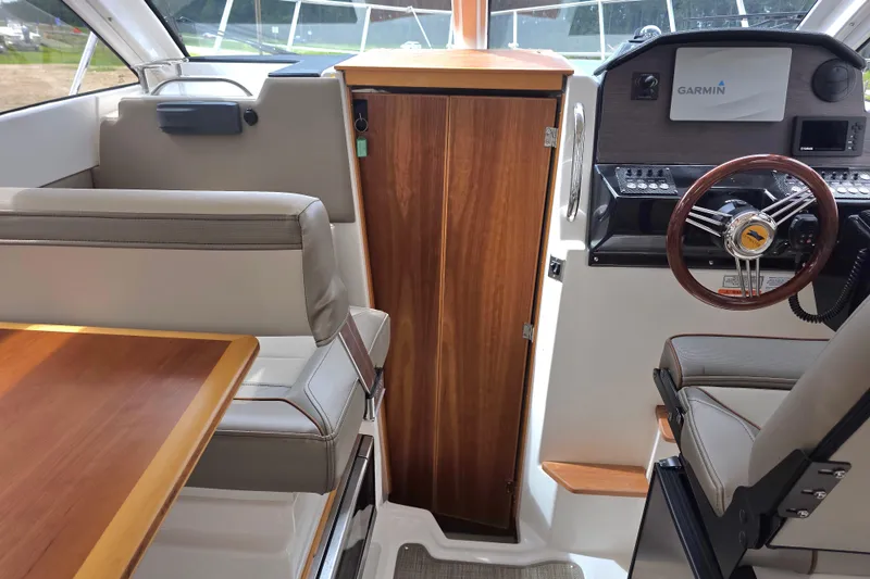 Slide: The Image of Interior of 2020 Cutwater C-24 boat with steering wheel and seating area. - 28