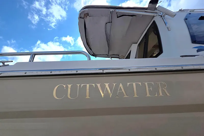 Slide: The Image of 2020 Cutwater C-24 boat with canopy against a blue sky background. - 6