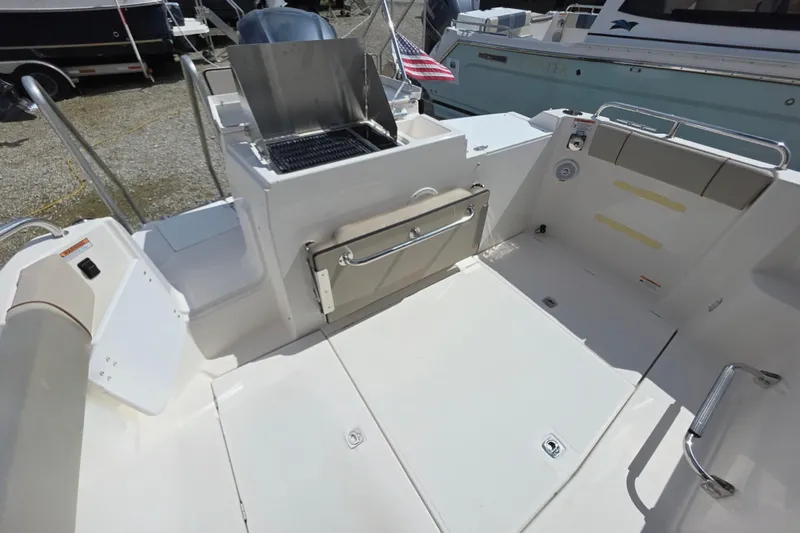 Slide: The Image of 2020 Cutwater C-24 boat deck with grill and seating area. - 7
