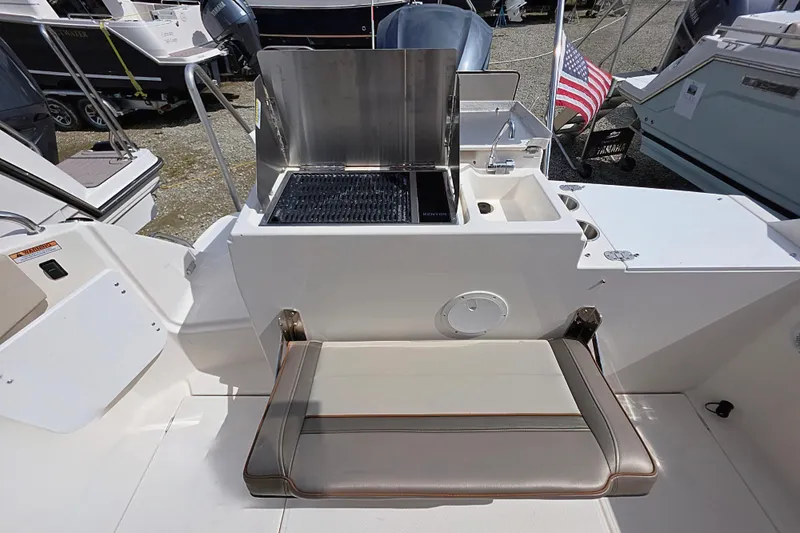 Slide: The Image of 2020 Cutwater C-24 boat with outdoor grill and seating area. - 9