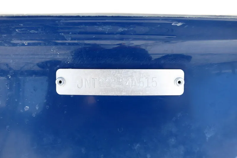 Slide: The Image of 2015 NauticStar 203SC Sport Deck boat identification plate on blue hull. - 13