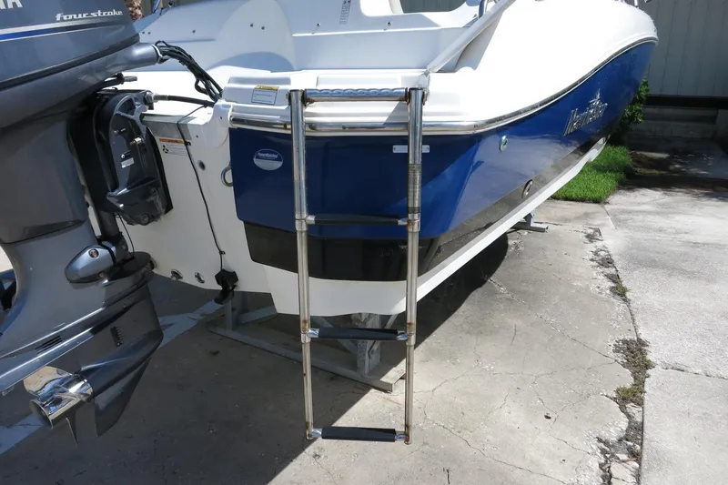 Slide: The Image of 2015 NauticStar 203SC Sport Deck boat with ladder and outboard motor. - 16