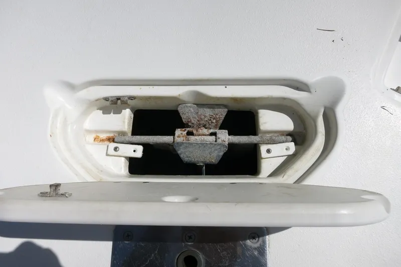Slide: The Image of Anchor compartment of 2015 NauticStar 203SC Sport Deck boat, showing rusted metal components. - 19