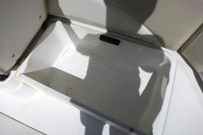 Slide: The Image of Storage compartment in 2015 NauticStar 203SC Sport Deck boat, open and empty. - 21