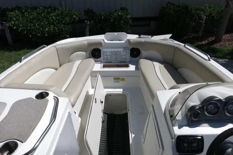 Slide: The Image of 2015 NauticStar 203SC Sport Deck boat interior with beige seating and dashboard. - 24