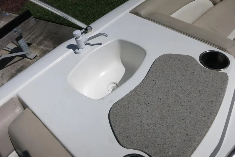 Slide: The Image of 2015 NauticStar 203SC Sport Deck boat sink and seating area. - 25