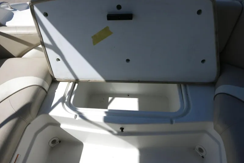 Slide: The Image of Open storage compartment on a 2015 NauticStar 203SC Sport Deck boat. - 31