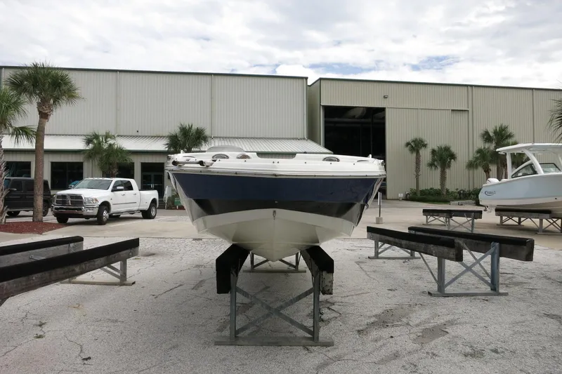 Slide: The Image of 2015 NauticStar 203SC Sport Deck boat on display outside a warehouse. - 42