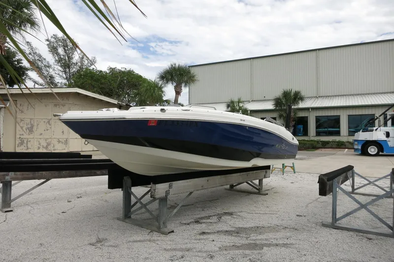 Slide: The Image of 2015 NauticStar 203SC Sport Deck boat on display at a marina. - 43