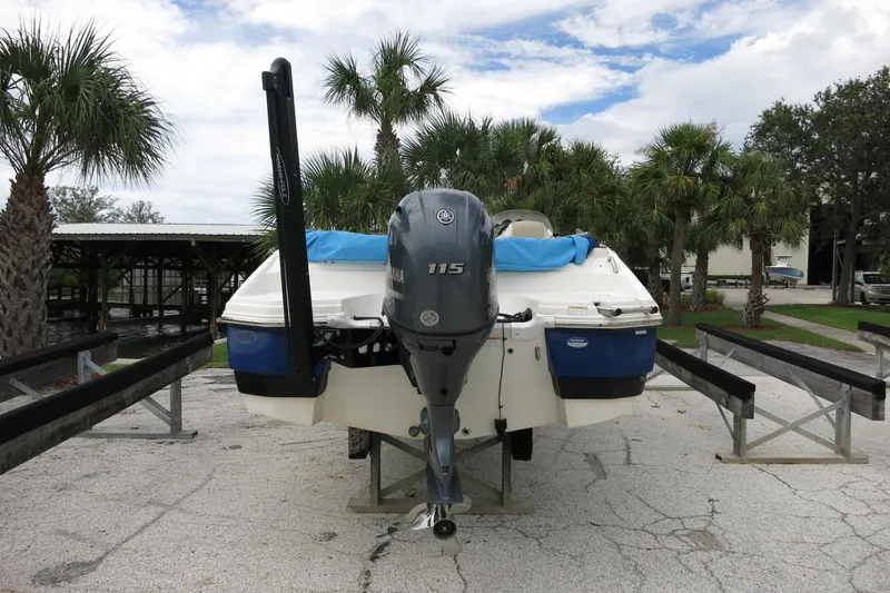 Slide: The Image of 2015 NauticStar 203SC Sport Deck boat on trailer, surrounded by palm trees. - 46