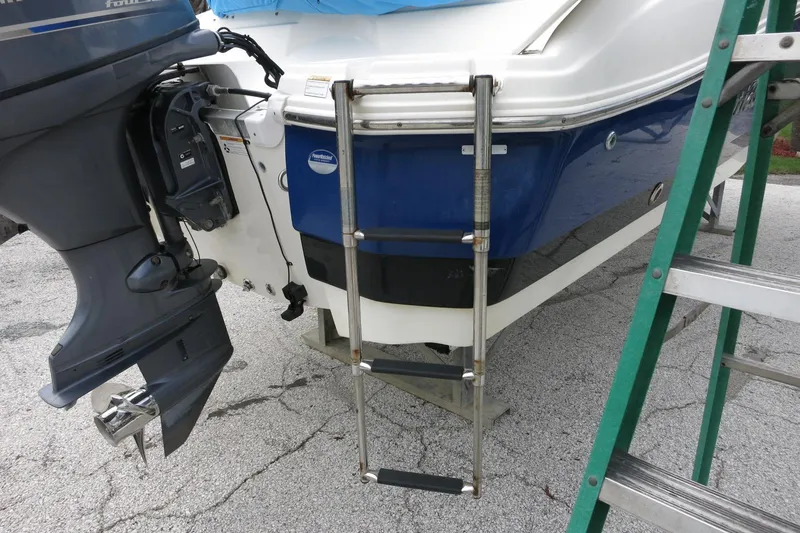 Slide: The Image of 2015 NauticStar 203SC Sport Deck boat with ladder and outboard motor. - 49