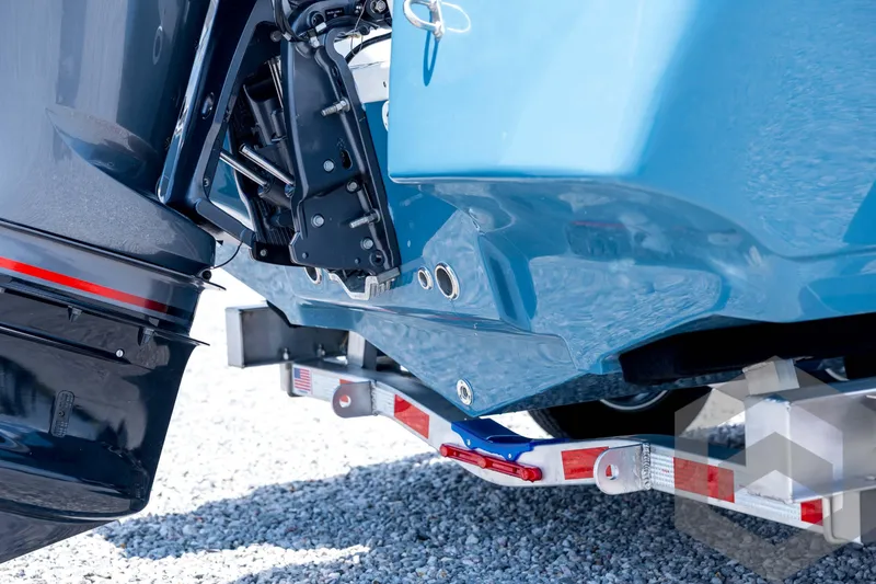 Slide: The Image of 2026 Tidewater 2110 Bay Max boat on trailer, close-up of motor and hull. - 19