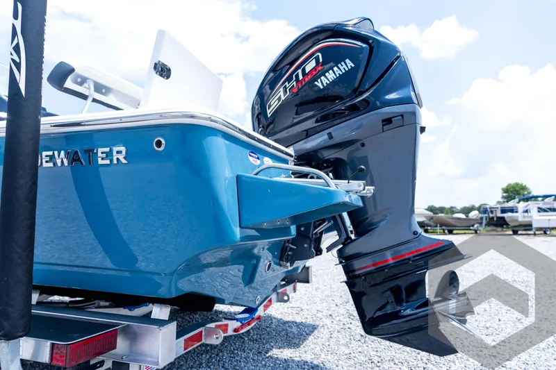 Slide: The Image of 2026 Tidewater 2110 Bay Max boat with Yamaha engine, parked on gravel. - 29