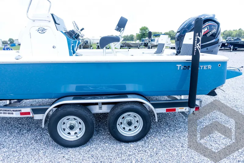 Slide: The Image of 2026 Tidewater 2110 Bay Max boat on trailer, blue hull, parked on gravel. - 33