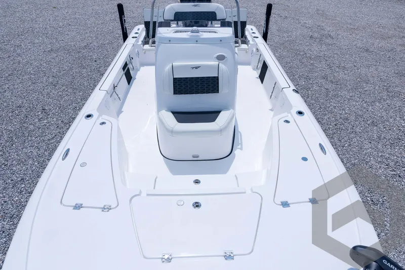 Slide: The Image of 2026 Tidewater 2110 Bay Max boat interior with seating and console, on gravel surface. - 40