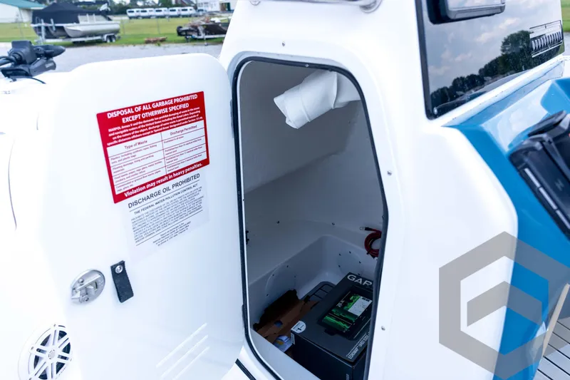 Slide: The Image of 2026 Tidewater 2110 Bay Max boat storage compartment with battery and safety instructions. - 60