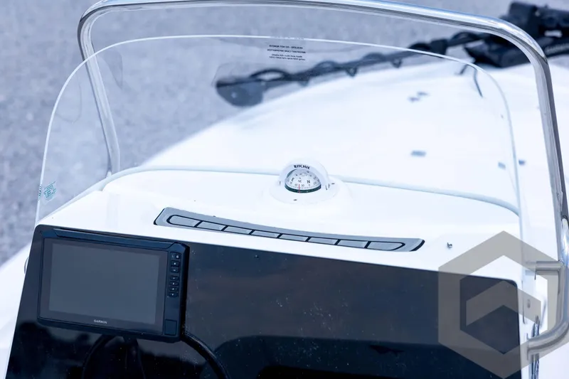 Slide: The Image of 2026 Tidewater 2110 Bay Max boat dashboard with compass and Garmin display. - 63