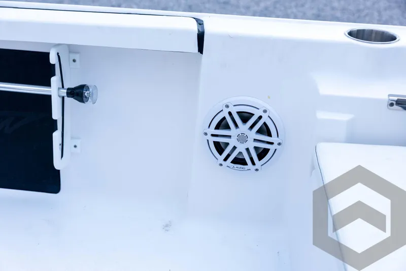 Slide: The Image of 2026 Tidewater 2110 Bay Max boat interior with JL Audio speaker and cup holder. - 73