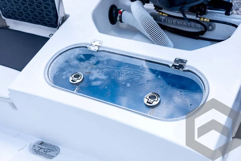 Slide: The Image of 2026 Tidewater 2110 Bay Max boat livewell with clear lid and water inside. - 80