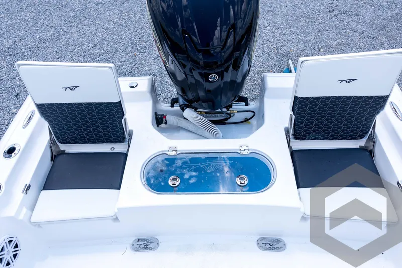 Slide: The Image of 2026 Tidewater 2110 Bay Max boat interior with seating and motor, showcasing modern design. - 81