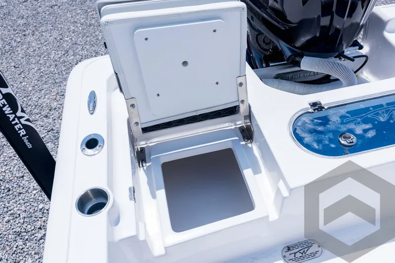 Slide: The Image of 2026 Tidewater 2110 Bay Max boat with open storage compartment and engine detail. - 82