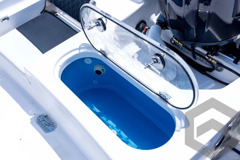 Slide: The Image of 2026 Tidewater 2110 Bay Max boat with open livewell and engine detail. - 84