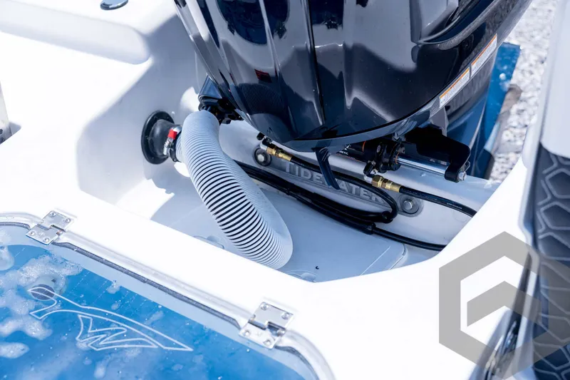 Slide: The Image of 2026 Tidewater 2110 Bay Max boat engine compartment with visible hoses and fittings. - 85