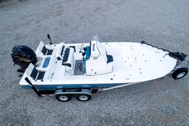 Slide: The Image of 2026 Tidewater 2110 Bay Max boat on trailer, featuring Yamaha engine, parked on gravel. - 94
