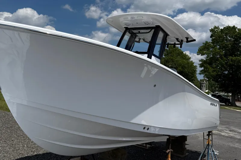 The Image of 2026 Sportsman Open 232 Center Console boat on display under a cloudy sky. - 0