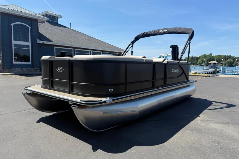 Slide: The Image of 2026 Bentley Pontoons LE 200 CW pontoon boat parked near a marina. - 1