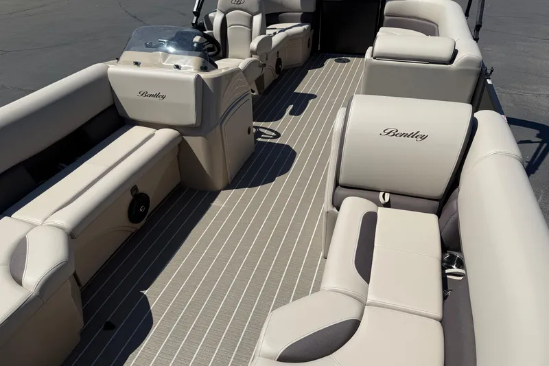 Slide: The Image of 2026 Bentley Pontoons LE 200 CW interior with luxurious beige seating and steering console. - 14