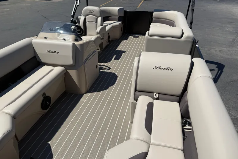 Slide: The Image of 2026 Bentley Pontoons LE 200 CW interior with beige seating and modern dashboard. - 15