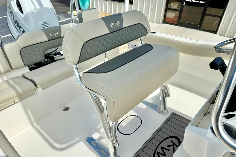 Slide: The Image of 2025 Key West 203 FS boat interior with cushioned seating and Suzuki engine. - 18